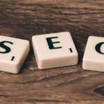 On-Page SEO - Three White-and-black Scrabble Tiles on Brown Wooden Surface