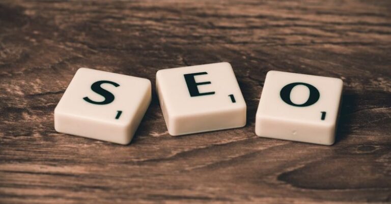 On-Page SEO - Three White-and-black Scrabble Tiles on Brown Wooden Surface