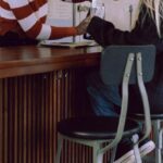 Customer Engagement - A woman sitting at a bar with a man