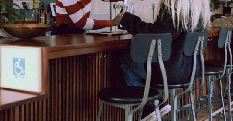 Customer Engagement - A woman sitting at a bar with a man