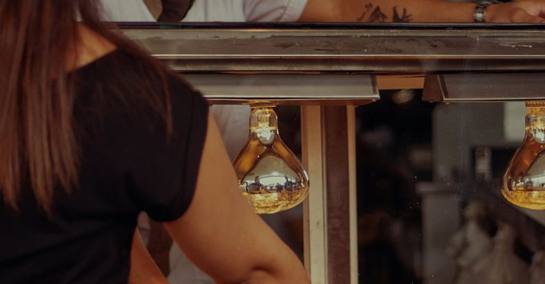 Customer Interaction - Chef Smiling and Looking at Customer Standing by Bar Counter