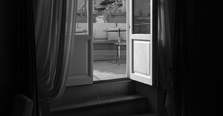 Open Rates - A black and white photo of a window with a view