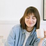 Automated Email - Woman Drinking Coffee and Looking at a Laptop