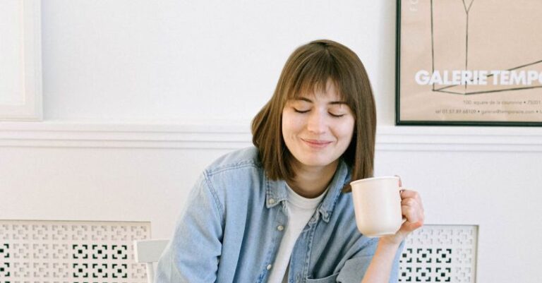 Automated Email - Woman Drinking Coffee and Looking at a Laptop