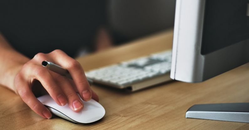 Cost-Per-Click - Person Holding Apple Magic Mouse