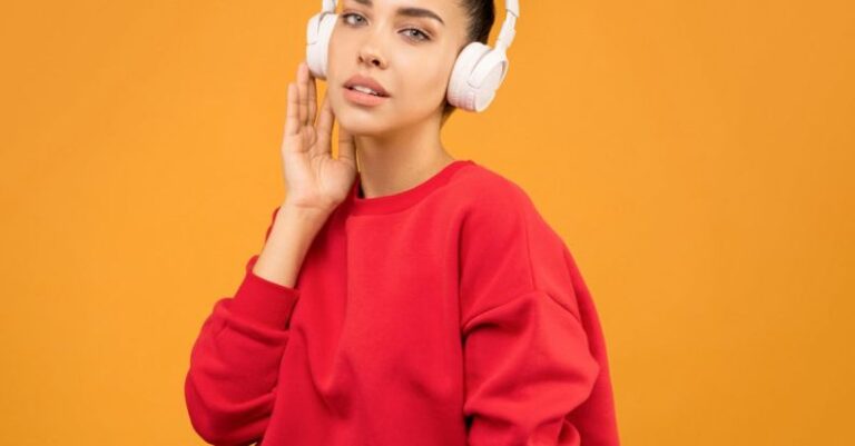 PPC Trends - Woman in Red Sweatshirt and Blue Jeans Wearing White Headphones