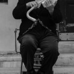 Website Performance - A man in top hat and cane playing violin