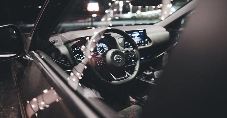 Brand Awareness - A car interior at night with the steering wheel and dashboard