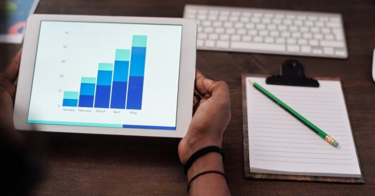 SEO Analytics - Person Holding White Ipad on Brown Wooden Table