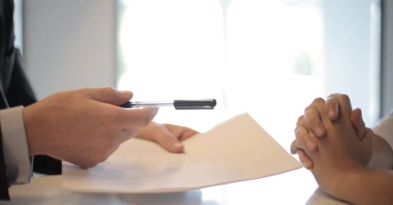 Marketing ROI - Crop businessman giving contract to woman to sign