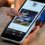 E-Commerce Websites - Person Using Black And White Smartphone and Holding Blue Card