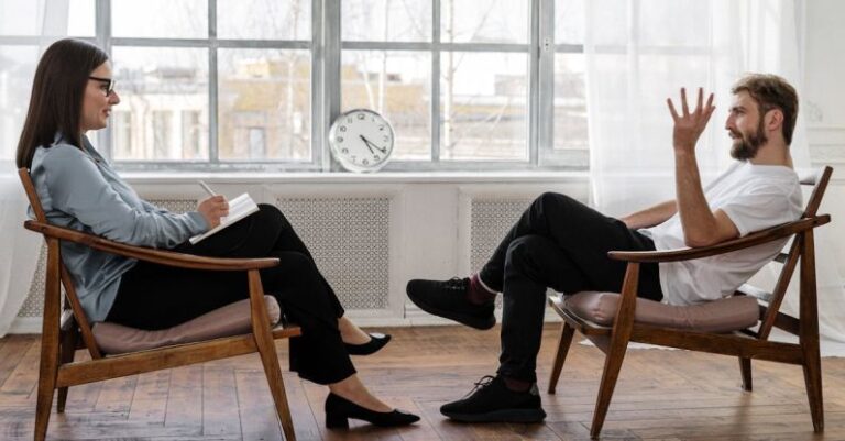 E-Commerce Analytics - Person in Black Pants and Black Shoes Sitting on Brown Wooden Chair